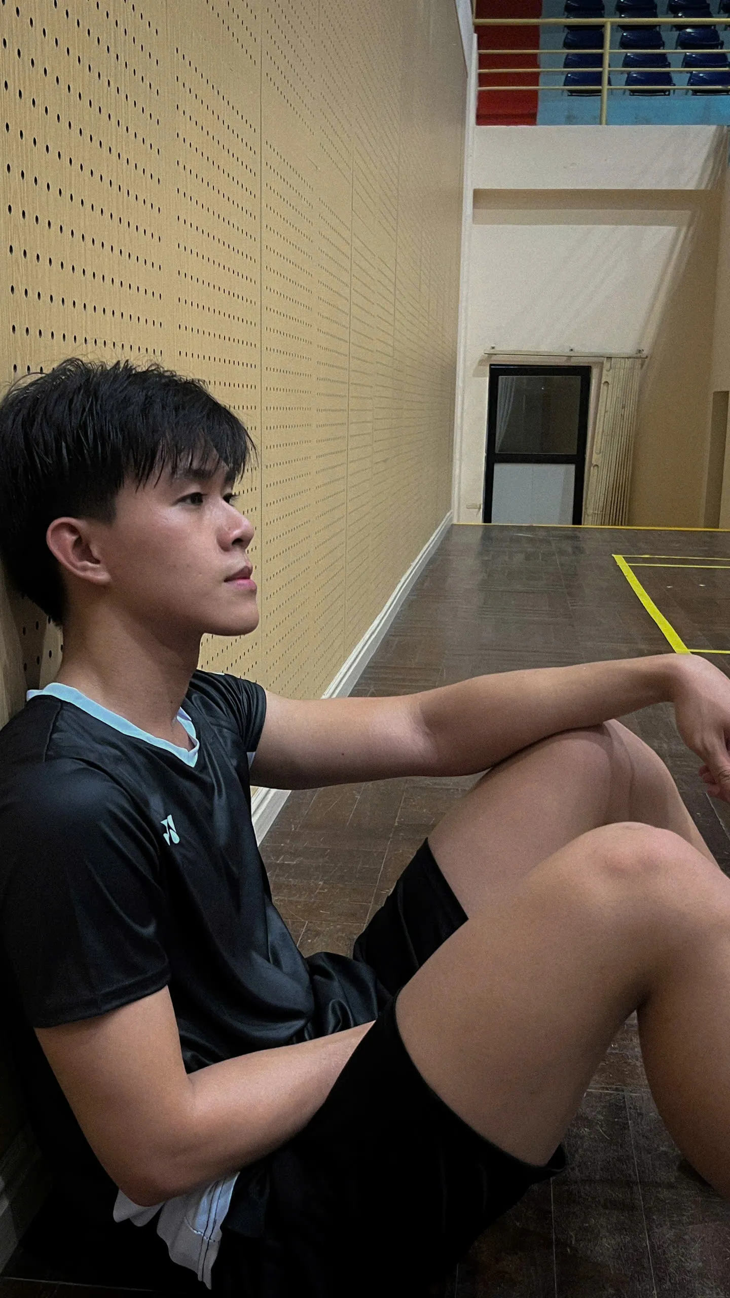 Resting beside an indoor sports court